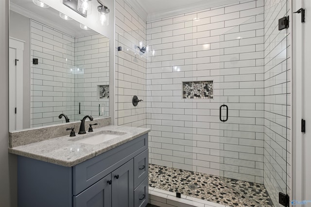 bathroom featuring ornamental molding, a shower stall, and vanity