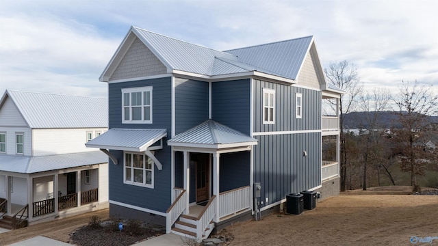 view of front of house featuring crawl space, metal roof, central air condition unit, and a porch