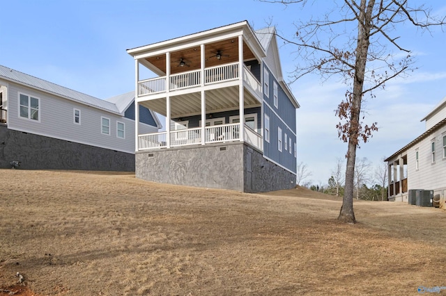 rear view of house with ceiling fan and central AC unit