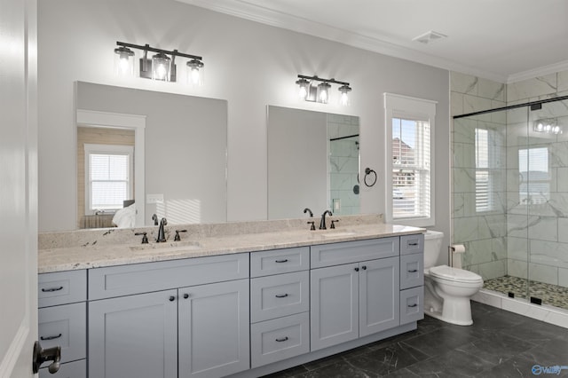 bathroom with ornamental molding, a sink, a shower stall, and toilet