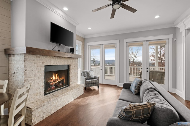 living area with french doors, ornamental molding, and wood finished floors