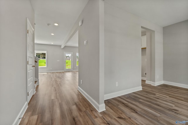 hallway with hardwood / wood-style flooring and beam ceiling