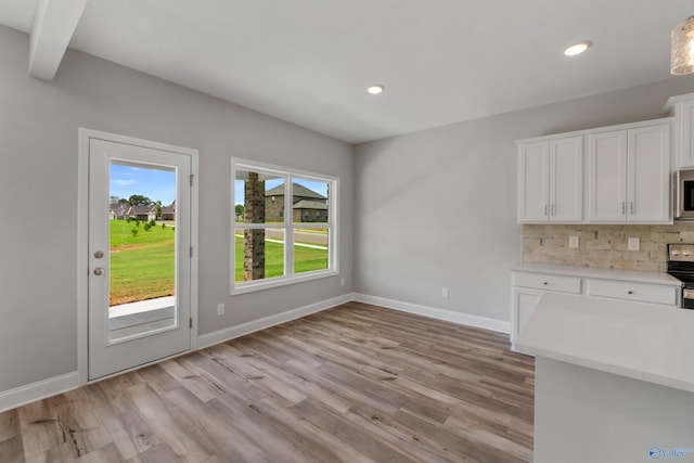 unfurnished dining area with light wood-type flooring