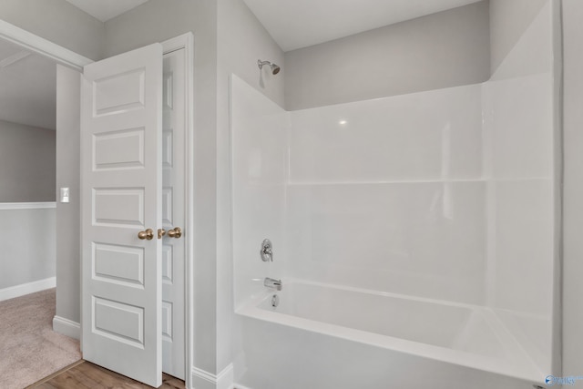 bathroom with tub / shower combination and wood-type flooring