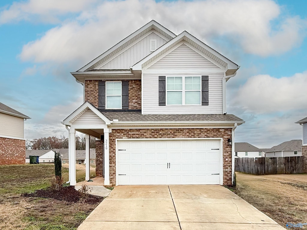 view of front of property with a front yard and a garage