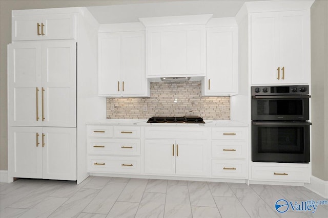 kitchen featuring light stone countertops, stainless steel double oven, gas cooktop, backsplash, and extractor fan