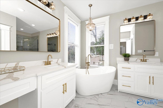 bathroom with vanity, separate shower and tub, and a notable chandelier