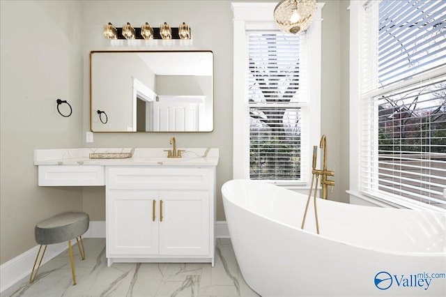 bathroom with vanity and a tub