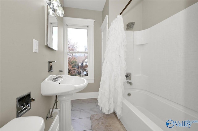 bathroom with toilet and shower / tub combo with curtain