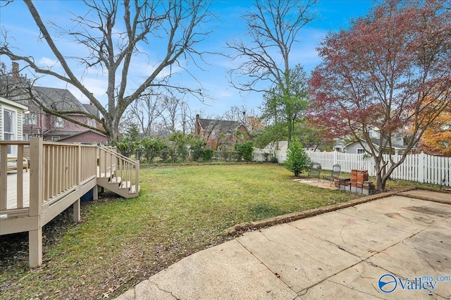 view of yard featuring a patio area and a deck