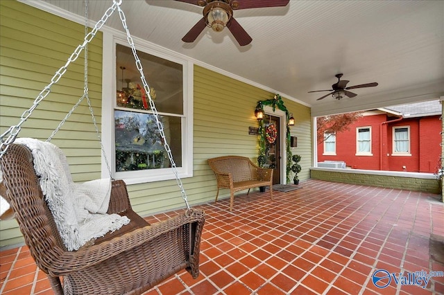 view of patio with ceiling fan and a porch