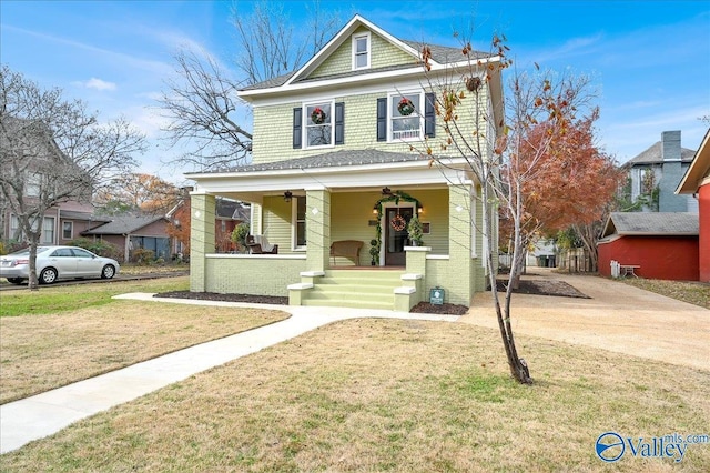 view of front of home featuring covered porch and a front lawn