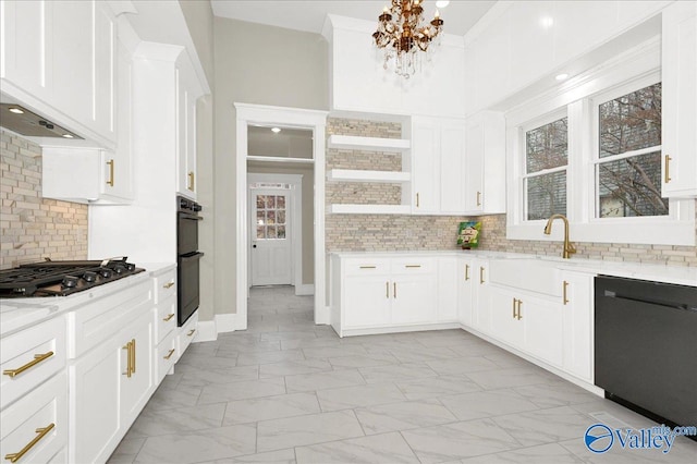 kitchen with backsplash, black appliances, light stone counters, white cabinetry, and a chandelier