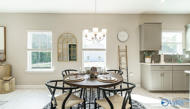 211 Bent Creek Ln, New Market, AL 35761 - dining space with light wood finished floors, a chandelier, and baseboards