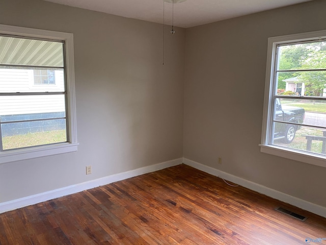 empty room with dark wood-type flooring