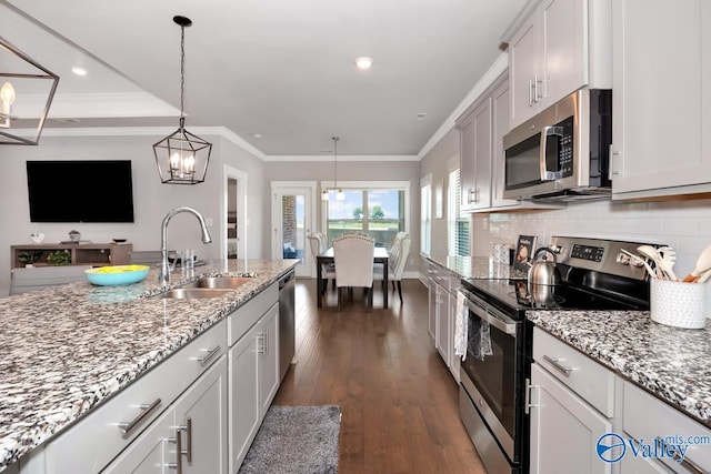 14614 Demarie Ln, Athens, AL 35613 - kitchen featuring stainless steel appliances, dark wood-type flooring, crown molding, decorative backsplash, and light stone counters