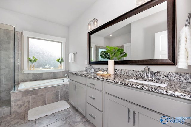 14614 Demarie Ln, Athens, AL 35613 - full bath featuring double vanity, a garden tub, tile patterned flooring, and tiled shower