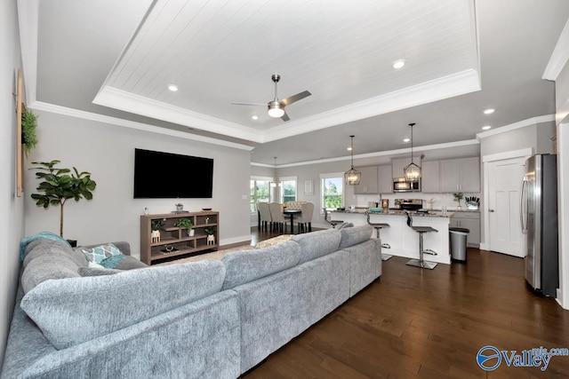 14614 Demarie Ln, Athens, AL 35613 - living room featuring a raised ceiling, a ceiling fan, dark wood finished floors, recessed lighting, and crown molding