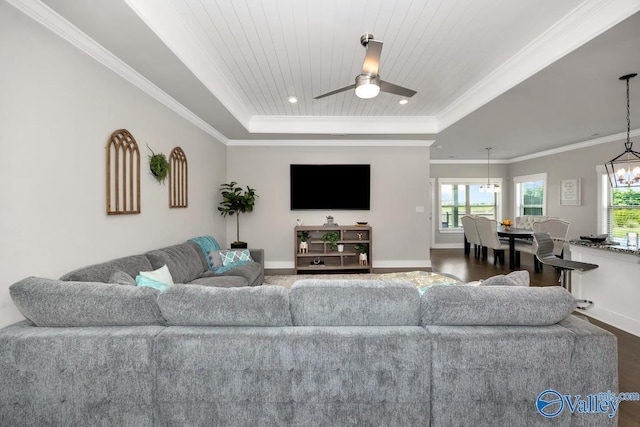 14614 Demarie Ln, Athens, AL 35613 - living room featuring a raised ceiling, plenty of natural light, ornamental molding, a chandelier, and ceiling fan