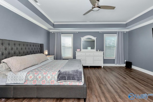 bedroom with ornamental molding, visible vents, baseboards, and wood finished floors