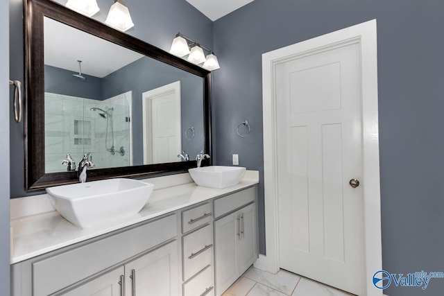 full bath with double vanity, a stall shower, marble finish floor, and a sink