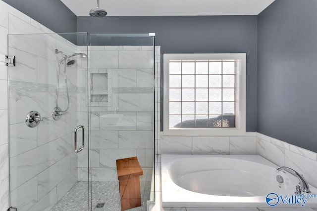 bathroom with a shower stall and a bath