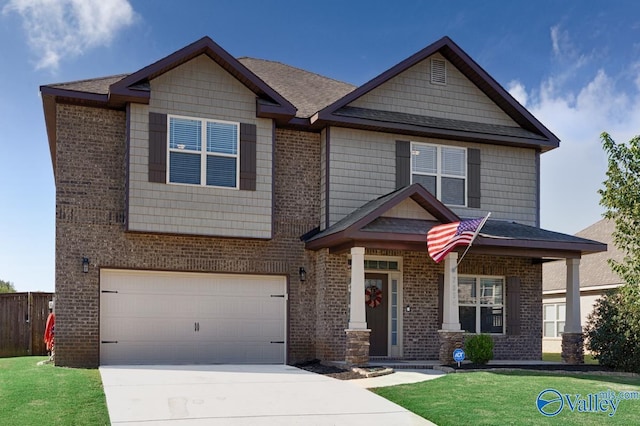 craftsman-style house featuring brick siding, concrete driveway, an attached garage, fence, and a front yard