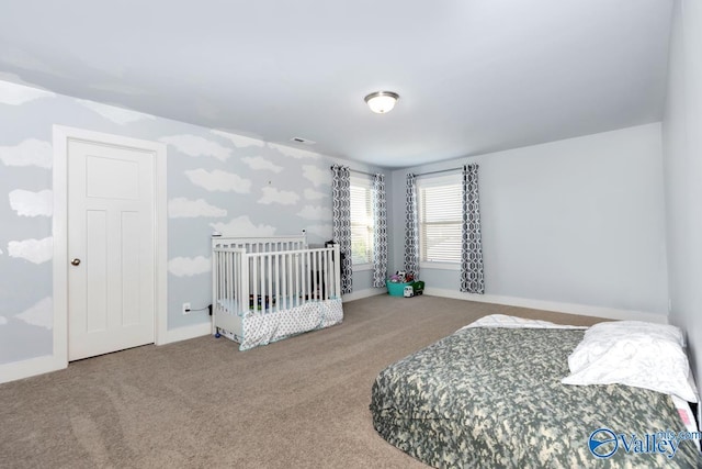 carpeted bedroom featuring baseboards and visible vents