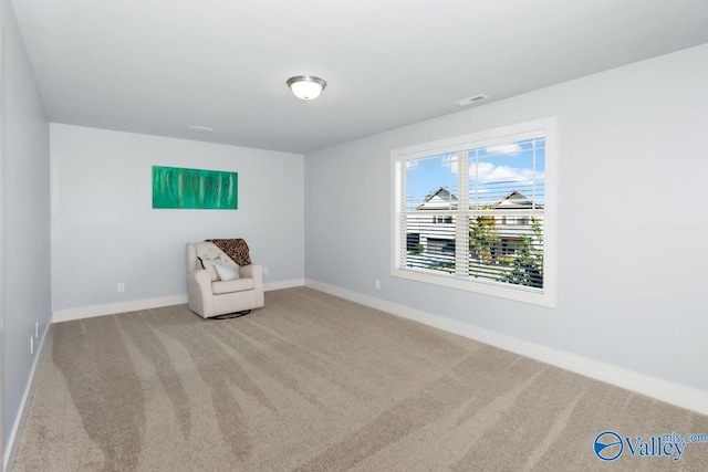 unfurnished room featuring carpet flooring, visible vents, and baseboards