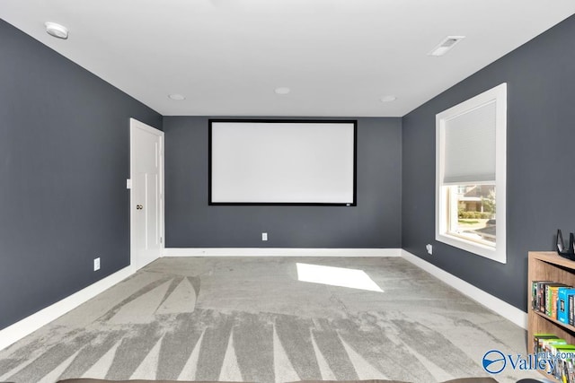 carpeted cinema with visible vents and baseboards