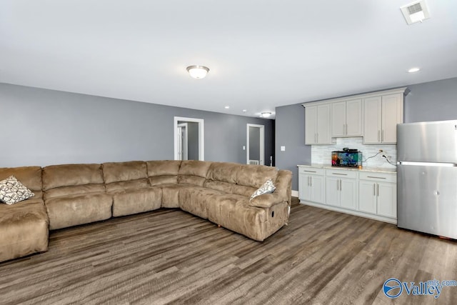 living area featuring wood finished floors, visible vents, and recessed lighting