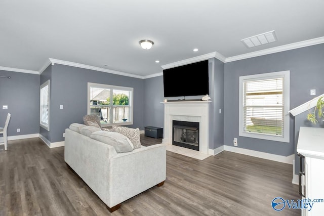 living room with a high end fireplace, visible vents, baseboards, and wood finished floors