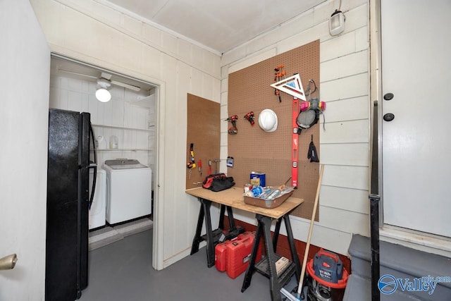 interior space featuring washing machine and clothes dryer and concrete floors