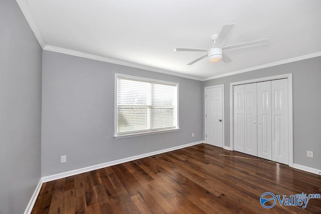 unfurnished bedroom featuring ornamental molding, wood-type flooring, ceiling fan, and baseboards