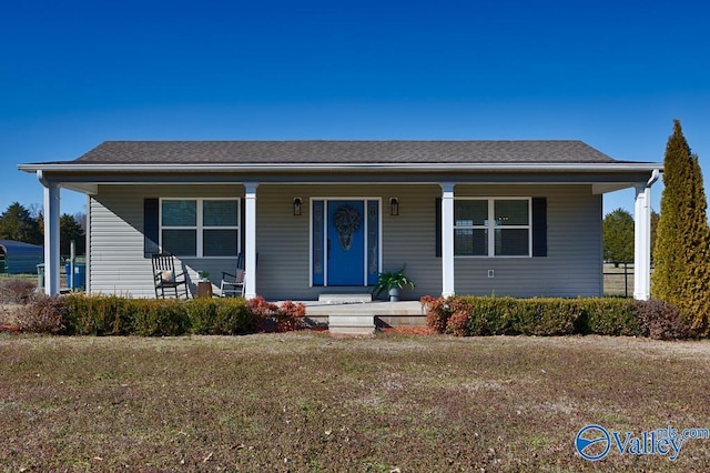 bungalow with a porch and a front lawn