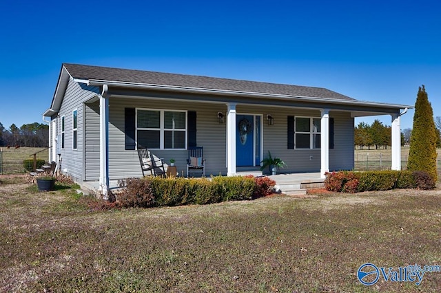 bungalow-style home with a shingled roof and covered porch