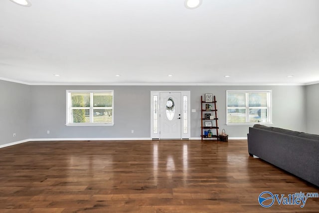 entrance foyer featuring crown molding, baseboards, wood finished floors, and recessed lighting