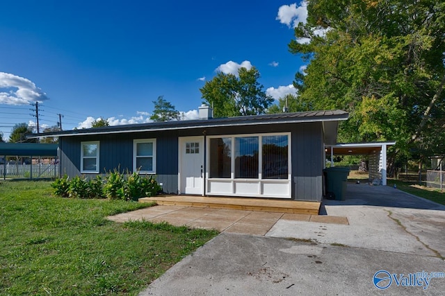 single story home with a front yard and a carport