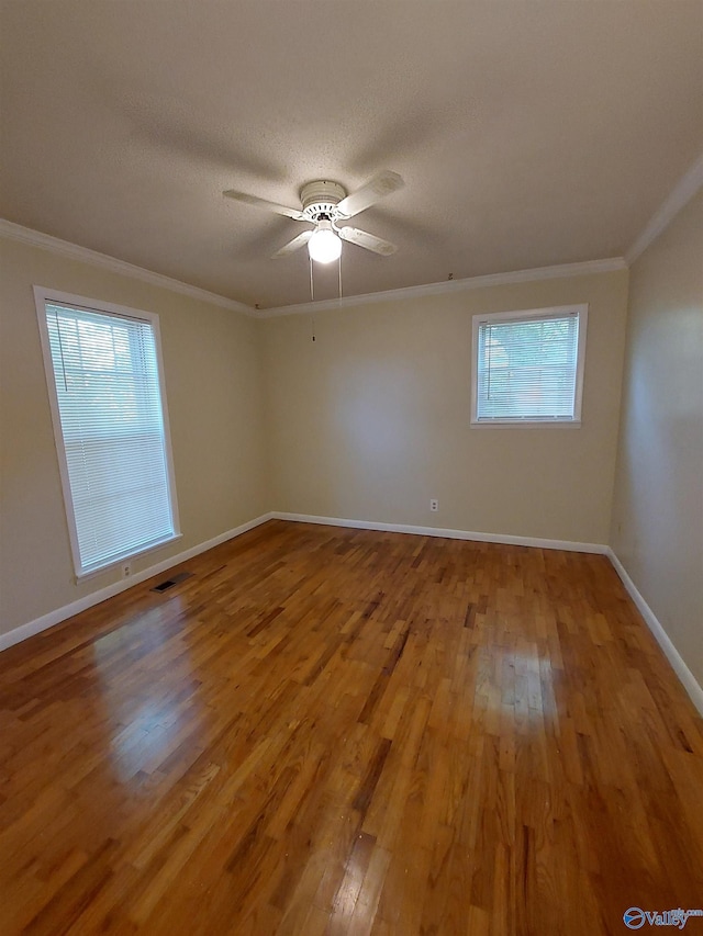 unfurnished room with hardwood / wood-style flooring, ceiling fan, ornamental molding, and a textured ceiling