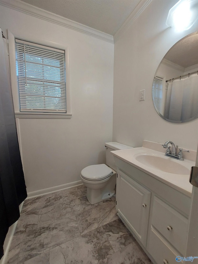 bathroom with crown molding, vanity, and toilet