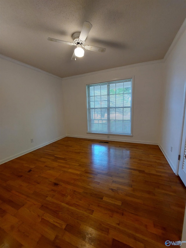 unfurnished room featuring crown molding, ceiling fan, dark hardwood / wood-style floors, and a textured ceiling