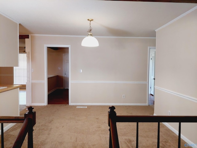 empty room featuring ornamental molding and carpet flooring