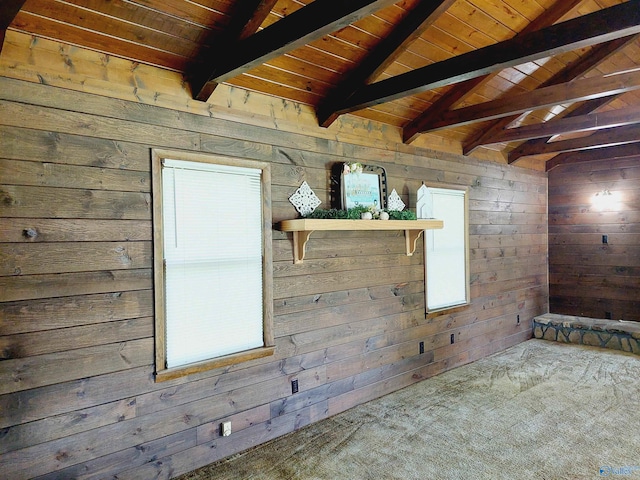 carpeted spare room featuring lofted ceiling with beams, wood ceiling, and wood walls