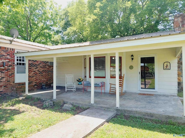 view of exterior entry featuring a patio area