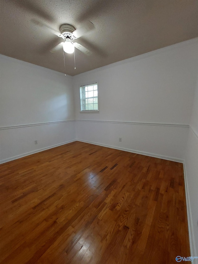 empty room featuring hardwood / wood-style floors and a textured ceiling