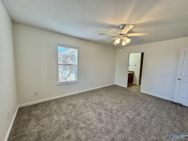 unfurnished bedroom with ceiling fan, carpet, a textured ceiling, and connected bathroom