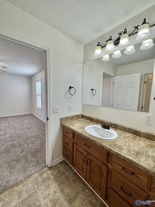 bathroom with a textured ceiling and vanity