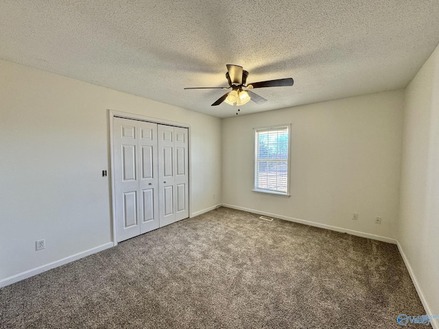 unfurnished bedroom with a textured ceiling, ceiling fan, carpet, and a closet