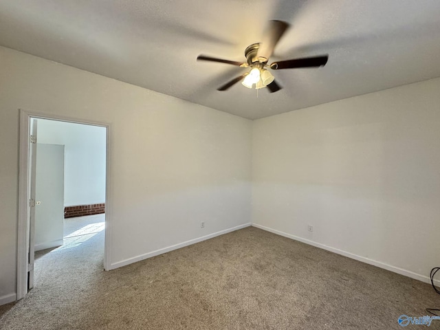 unfurnished room featuring ceiling fan and carpet flooring