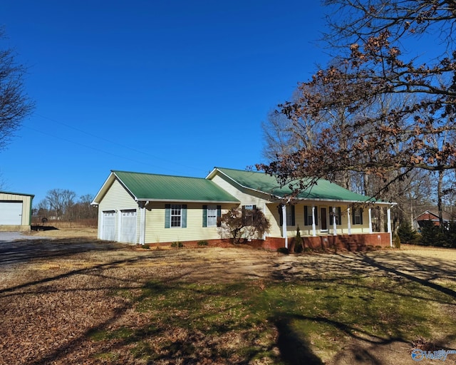 ranch-style house with a garage and a porch